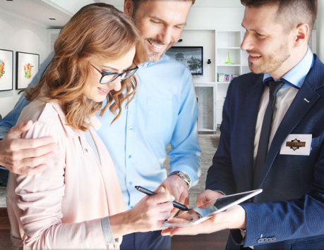 salesman with tablet in home with couple