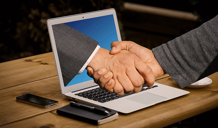 handshake through laptop screen