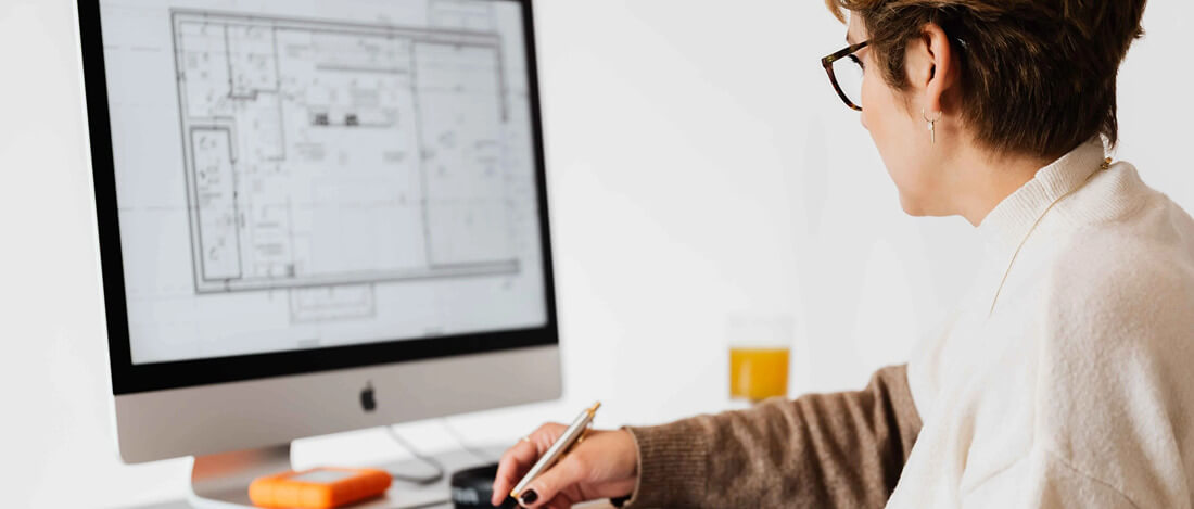 Woman on iMac displaying flooring designs